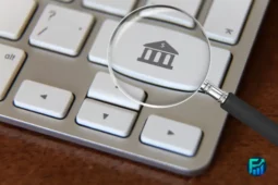 Magnifying glass over a keyboard key with a bank icon, symbolizing Deutsche Bank assists China.