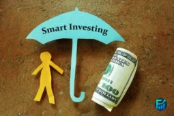 Cutout paper umbrella labeled “Smart Investing” protecting a paper figure and a rolled U.S. dollar bill.