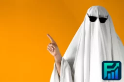 Person dressed as a ghost with sunglasses pointing up against an orange background, symbolising the concept of Ghost Jobs in the labour market.