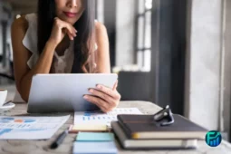 Woman analyzing charts on a tablet, representing smart investments.