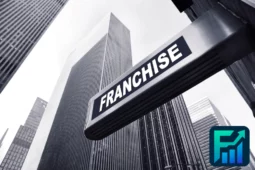 Franchise sign on a tall city building with financial logo, illustrating the concept of microfranchises in modern urban business settings.