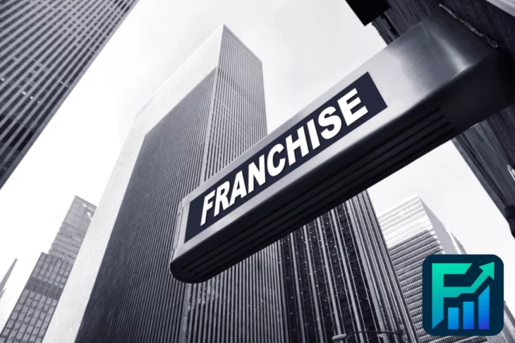 Franchise sign on a tall city building with financial logo, illustrating the concept of microfranchises in modern urban business settings.