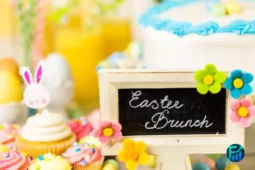 Colorful Easter Brunch table with cupcakes, cake, and festive decorations.
