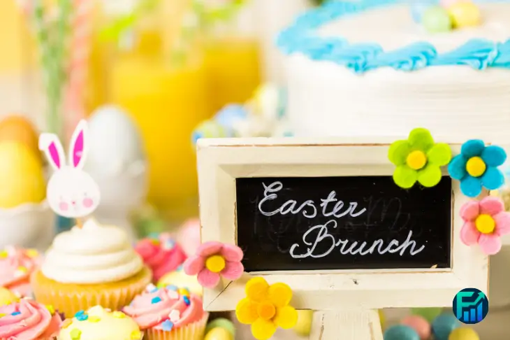 Colorful Easter Brunch table with cupcakes, cake, and festive decorations.