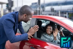 Man waving at two smiling people inside a red car, illustrating the concept of carpooling for commuting to work or school.