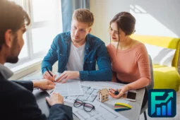 Young couple signs paperwork with an agent while buying property in Canada.