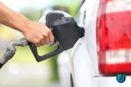 Person refueling a car at a gas station, illustrating savings with gas rewards apps.