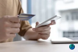 Person holding a credit card and smartphone, illustrating awareness of Credit Card Surcharges.