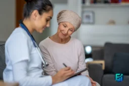 Healthcare worker assisting an older woman with paperwork related to medicaid redetermination.