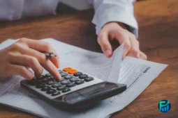 Hands reviewing tax documents and using a calculator during Tax Filing Prep.
