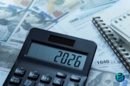 Calculator on tax forms and U.S. dollar bills, representing Tax Refund Early Filing.