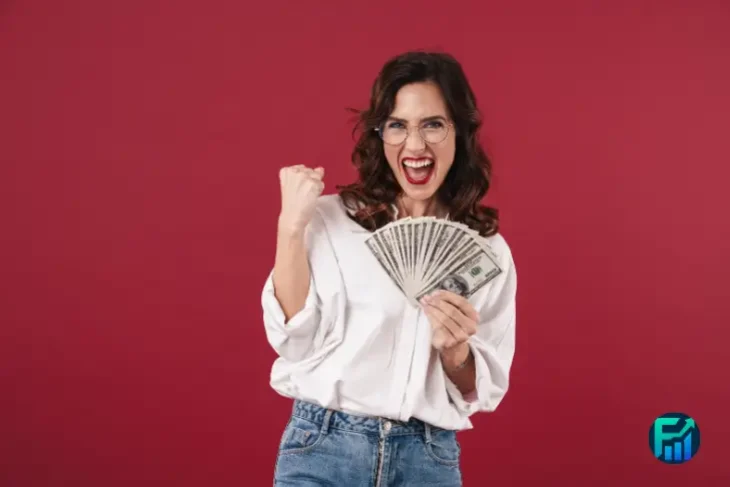 Woman celebrating with cash, representing how to find unclaimed money free through official state programs.