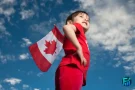 Child holding a Canadian flag outdoors, representing the Canada Child Benefit and family financial support in Canada.