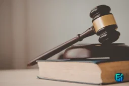 Car repossession laws, a judge’s gavel on top of a law book, symbolizing legal protections and repossession rules.