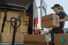 Gig worker taxes Canada worker loading delivery boxes into a van during a work shift.