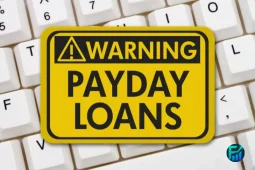 Warning sign about payday loans on a computer keyboard