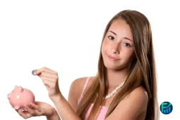 Teen girl saving coins in a piggy bank while learning about teaching teens about money and smart budgeting habits.