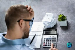 Person reviewing bills and expenses while building a financial cushion for unexpected costs.