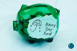 Green piggy bank labeled “rainy day fund.”