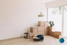 Rental assistance concept with moving boxes in an empty home.